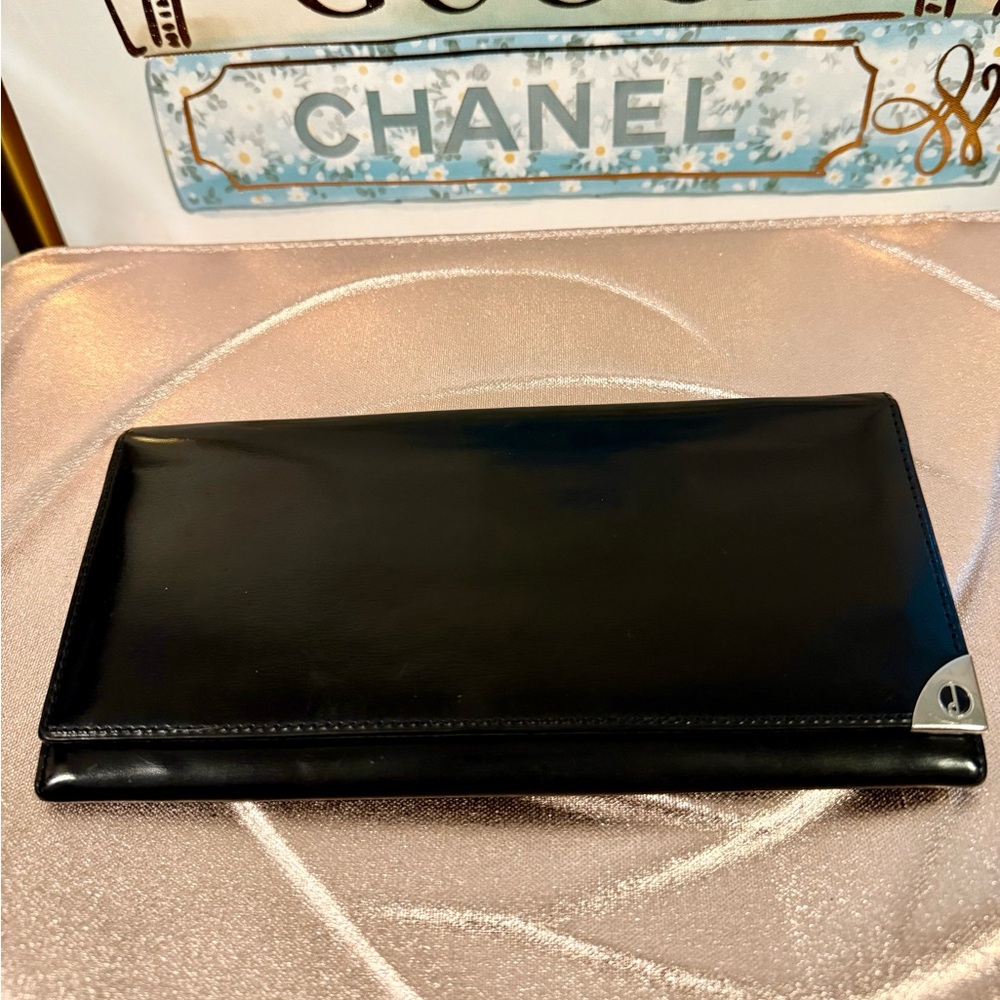 Vintage Dunhill, leather black wallet with silver corner accent.